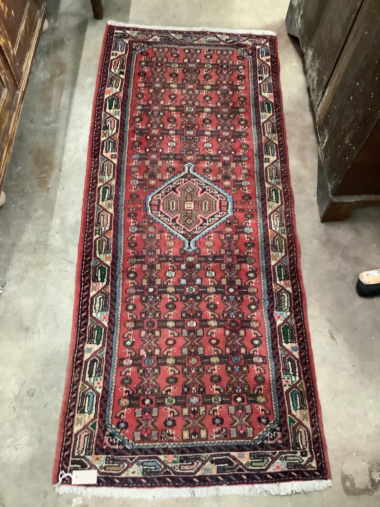 A Belouch red ground rug, 190 x 80cm